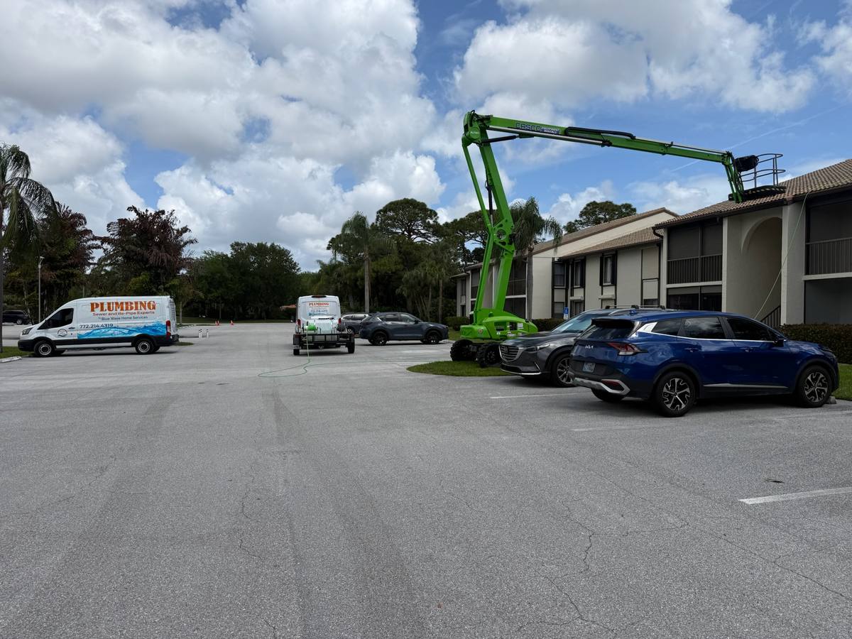 Blue Wave Home Services plumbing vans on a condo re-pipe job site