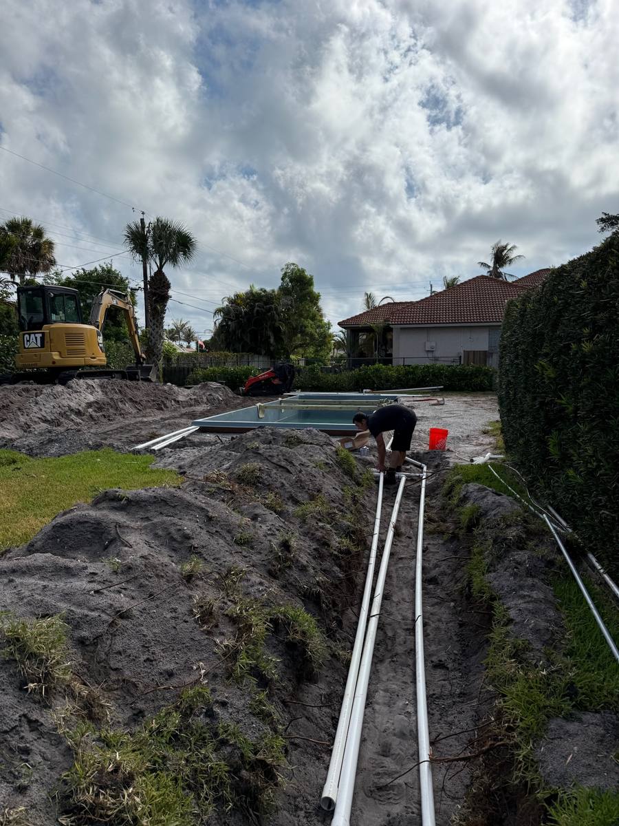 Plumber accessing a sewer mainline cleanout in Palm City, FL — photo 2