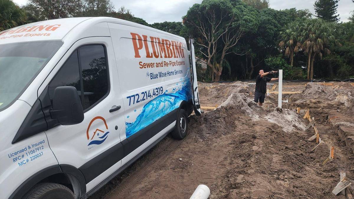 Plumber accessing a sewer mainline cleanout in Palm City, FL